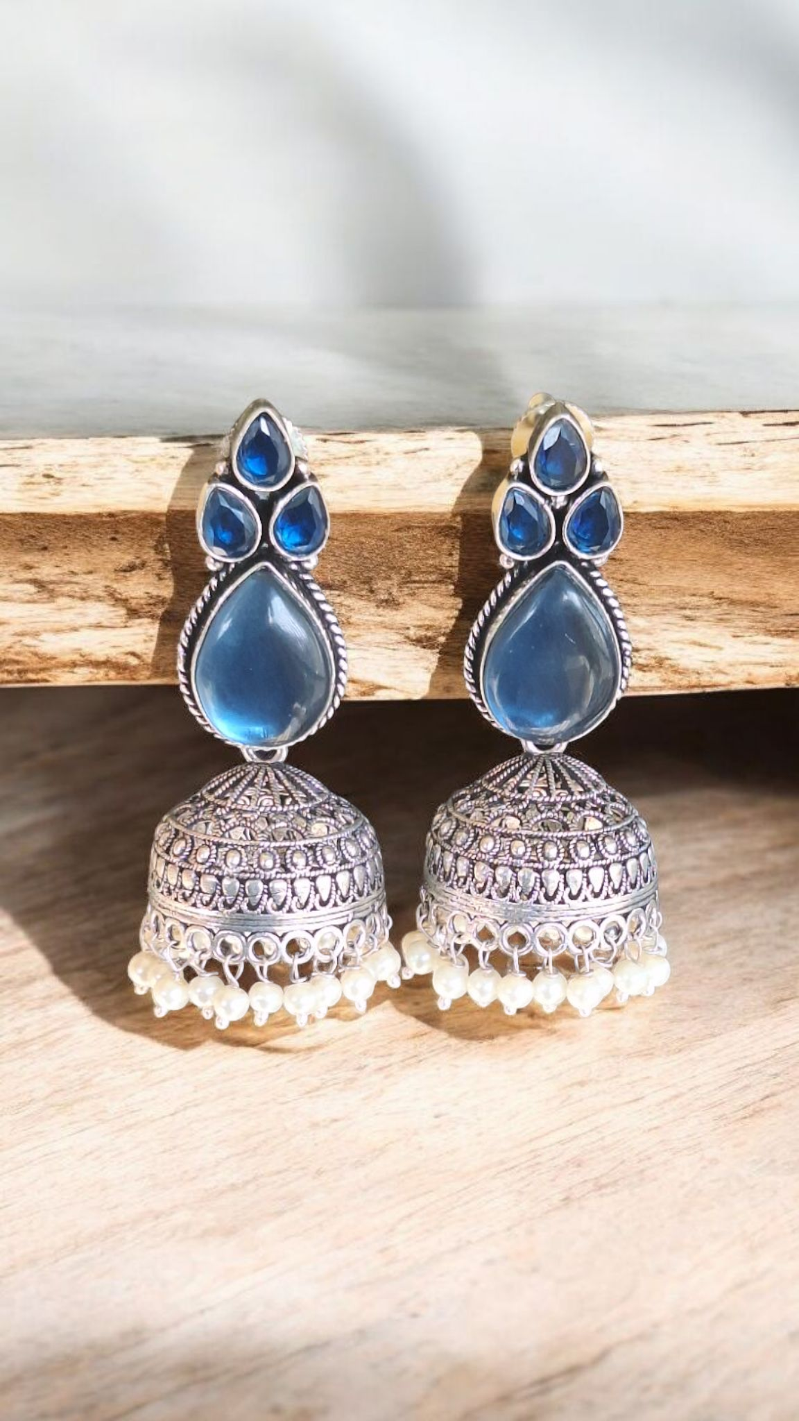 Elegant Stone Silver-Plated brass Jhumka Earrings with Pearl Detailing