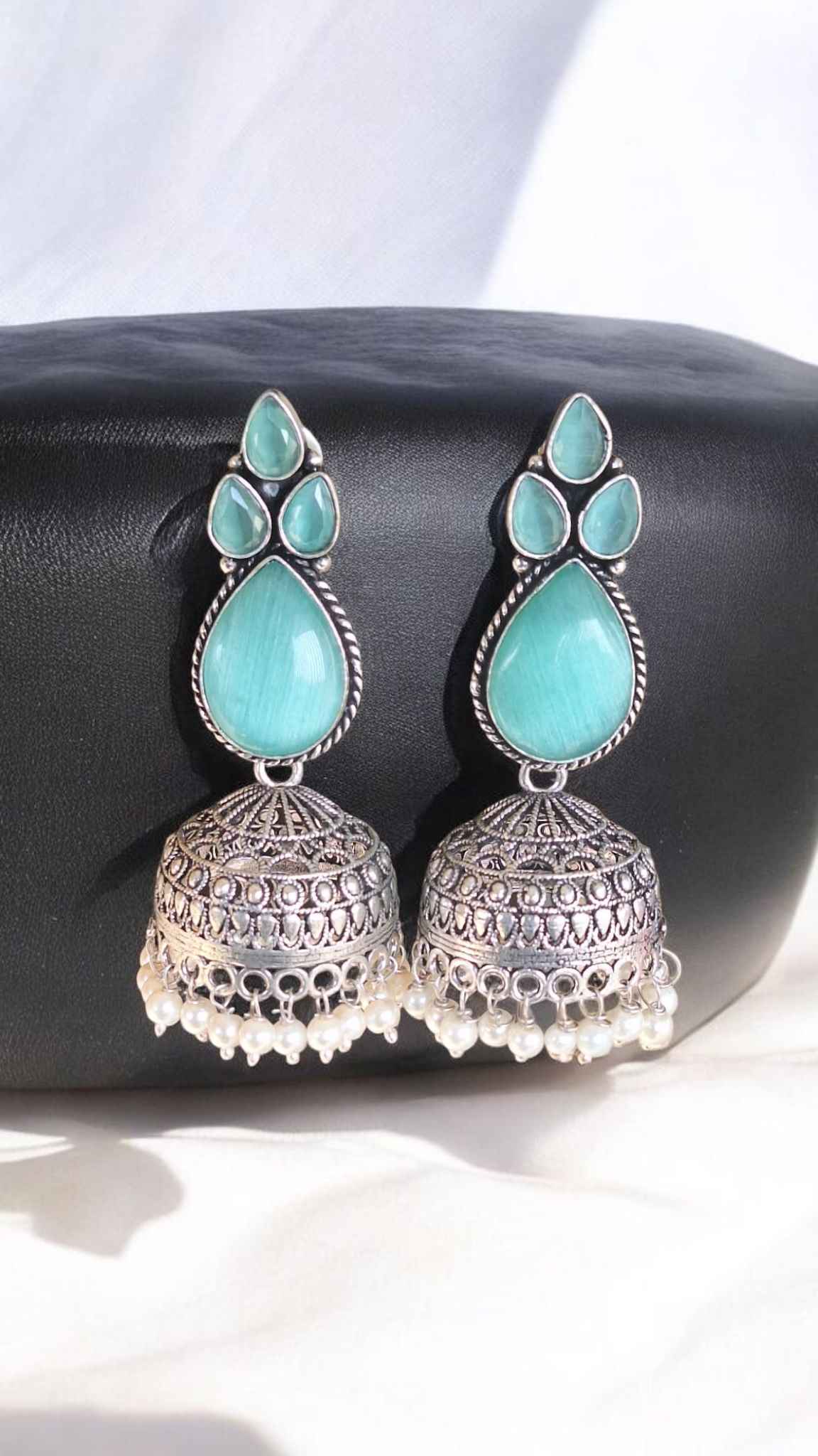 Elegant Stone Silver-Plated brass Jhumka Earrings with Pearl Detailing