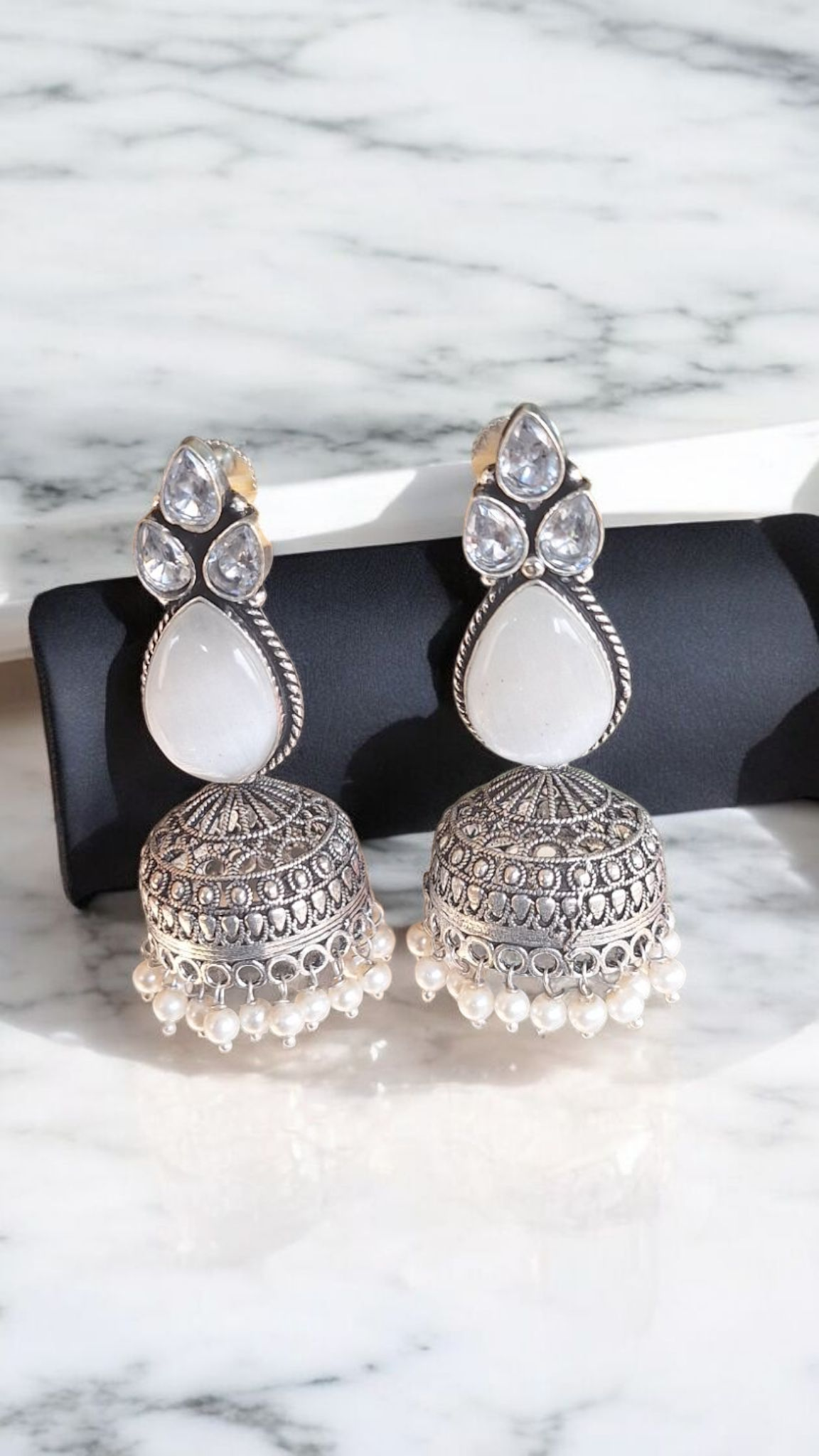Elegant Stone Silver-Plated brass Jhumka Earrings with Pearl Detailing