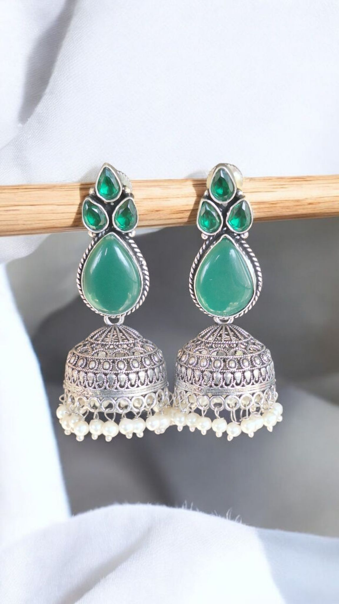 Elegant Stone Silver-Plated brass Jhumka Earrings with Pearl Detailing