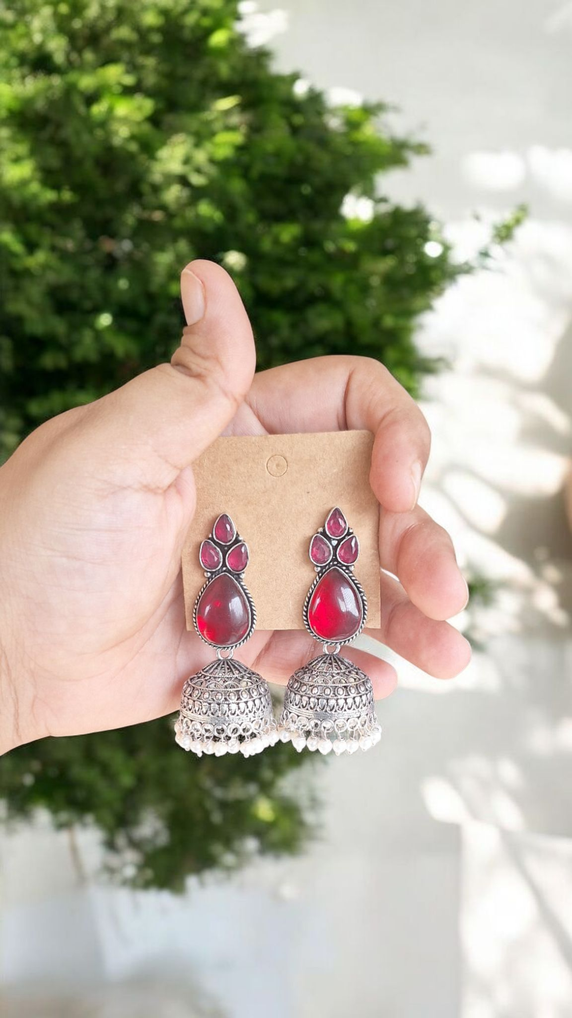 Elegant Stone Silver-Plated brass Jhumka Earrings with Pearl Detailing