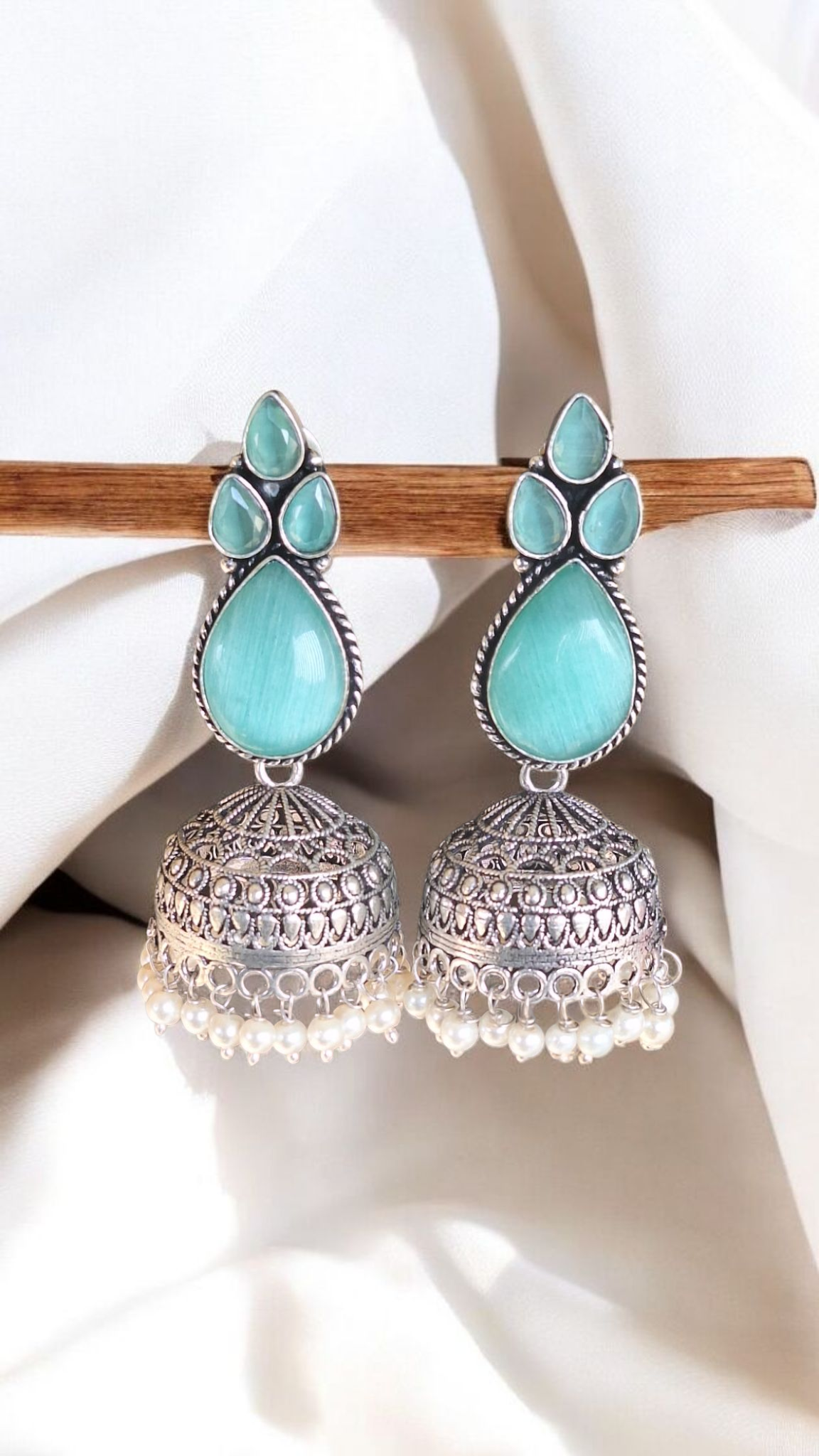 Elegant Stone Silver-Plated brass Jhumka Earrings with Pearl Detailing